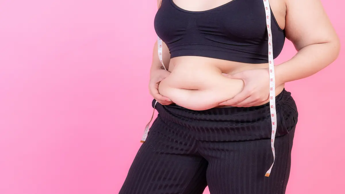 overweight-squeeze-belly-fat-with-measure-tape-her-neck_Activ Living Community