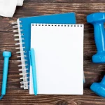 blue-notebook-with-dumbbells_Activ Living Community