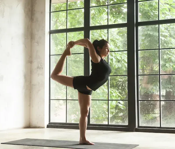 young-attractive-woman-natarajasana-pose-studio-background (1)_Activ Living Community