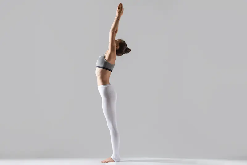 young-woman-tadasana-pose-grey-studio-background_Activ Living Community