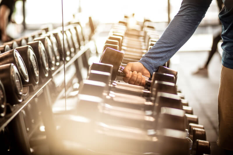 Sportsman Taking Weights From A Rack_Activ Living Community 