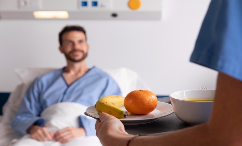 male-patient-bed-talking-nurse (1)_Activ Living Community