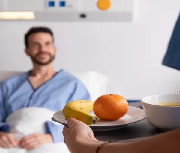 male-patient-with-jaundice-bed-talking-nurse (1)_Activ Living Community