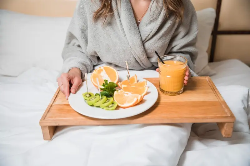 mid-section-woman-having-breakfast-with-glass-juice-bed (2)_Activ Living Community