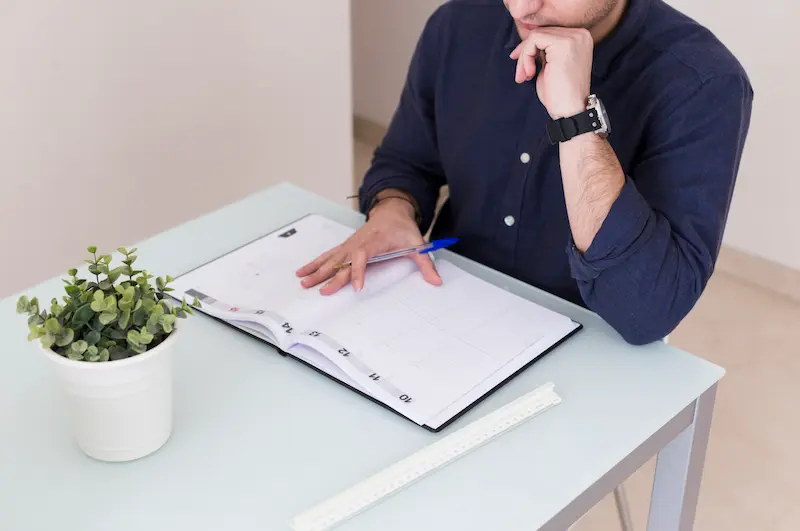 crop-man-reading-notes-notebook_Activ Living Community
