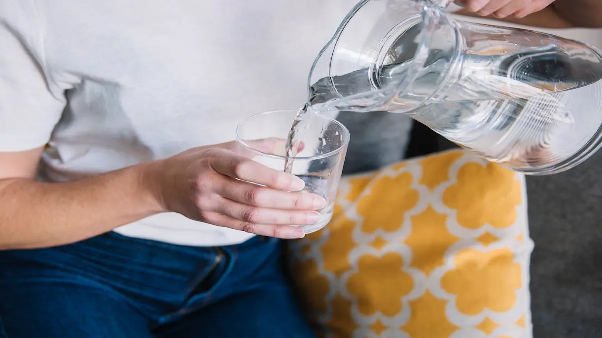 crop-woman-sofa-pouring-water_Activ Living Community