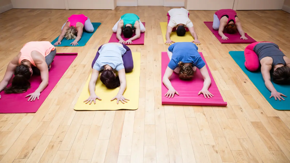 group-people-performing-childs-pose-yoga-exercise_Activ Living Community