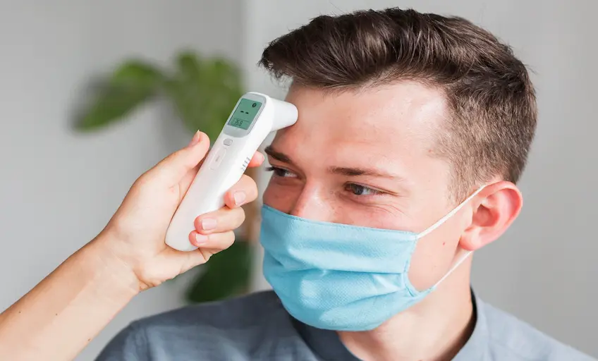 man-with-medical-mask-checking-temperature-office-with-thermometer_Activ Living Community