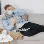 sick-guy-living-room-middle-age-man-feeling-sick-with-cold-fever-home-man-medical-mask_Activ Living Community