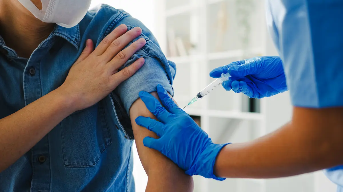 young-asian-lady-nurse-giving-pneumonia-flu-antivirus-vaccine-shot-senior-male-patient_Activ Living Community