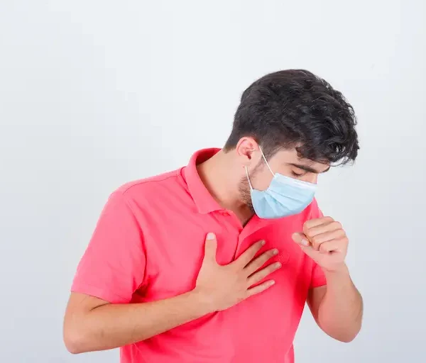 young-male-t-shirt-coughing-while-holding-hand-chest-looking-unwell-front-view_Activ Living Community