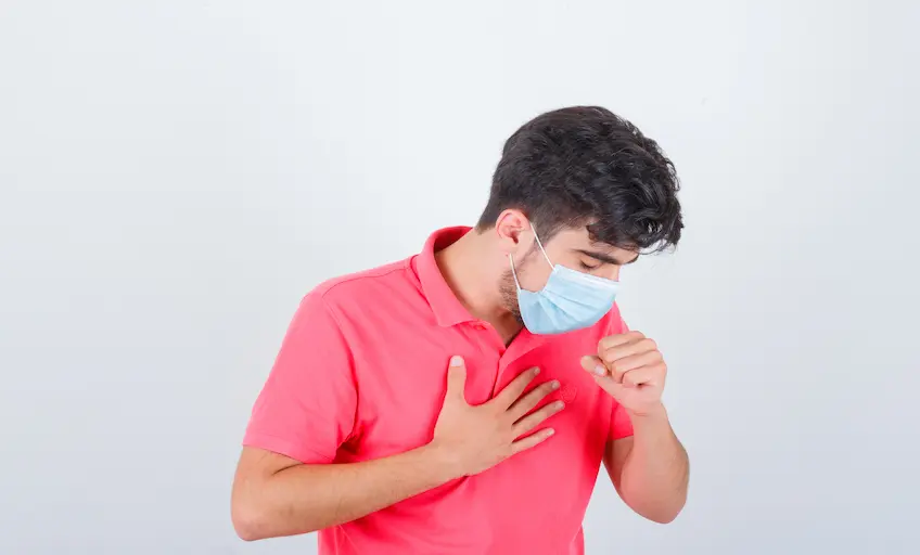 young-male-t-shirt-coughing-while-holding-hand-chest-looking-unwell-front-view_Activ Living Community