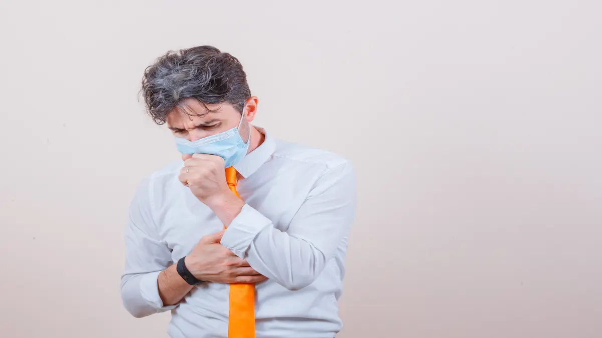 young-man-shirt-tie-mask-suffering-from-cough-looking-unwell_Activ Living Community