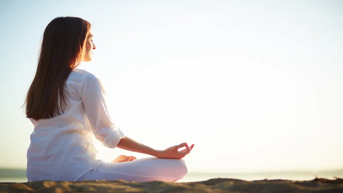 woman-sitting-yoga-pose-beach_Activ Living Community