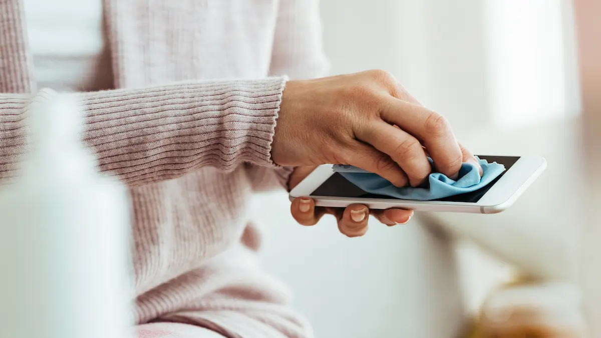 closeup-woman-using-fabric-cloth-while-cleaning-her-smart-phone-home_Activ Living Community